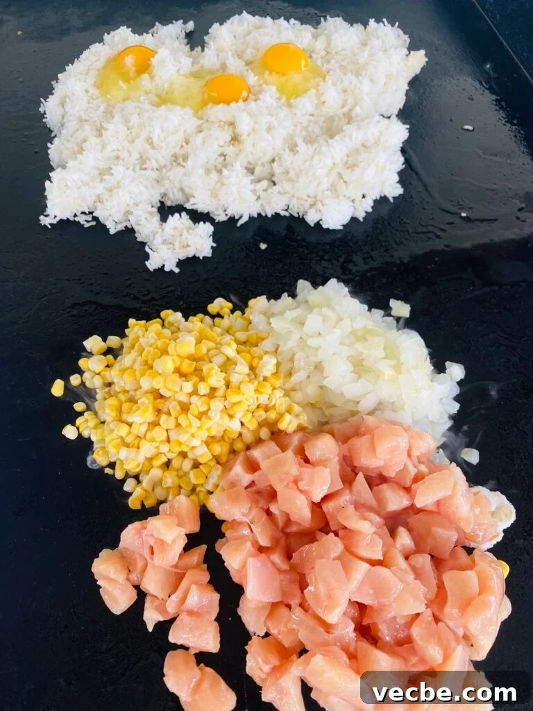Blackstone Cajun Fried Rice Recipe 4 starting the rice with veggies chicken rice and eggs on the griddle