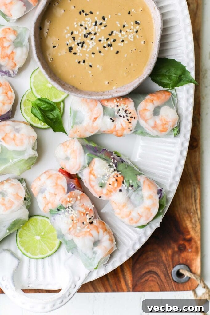 Vietnamese Spring Rolls Recipe with Peanut Dipping Sauce 2 Vietnamese spring rolls showns with a peanut dipping sauce.
