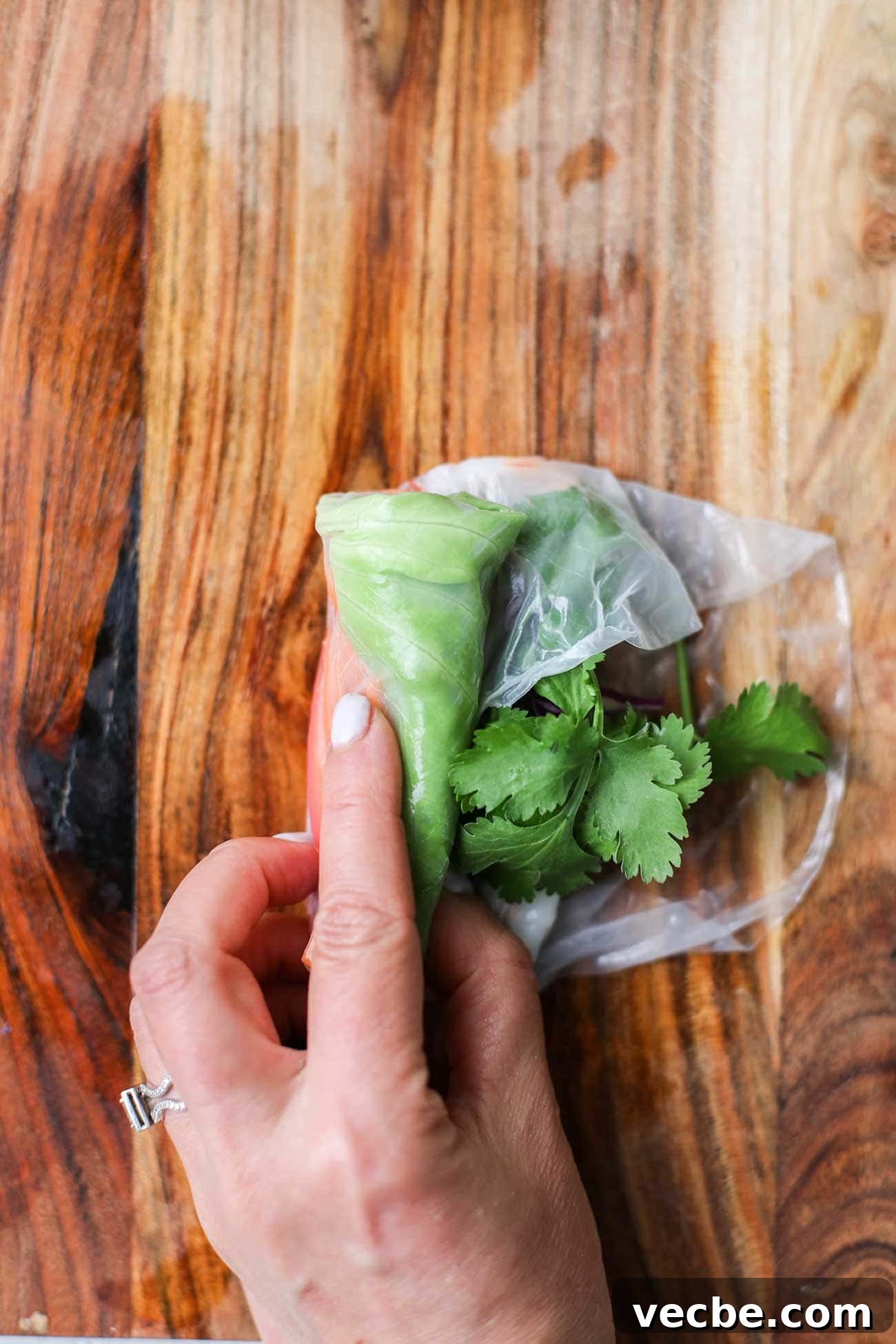 Vietnamese Spring Rolls Recipe with Peanut Dipping Sauce 13 Roll the wrapper from left to right into a tight burrito-like roll.