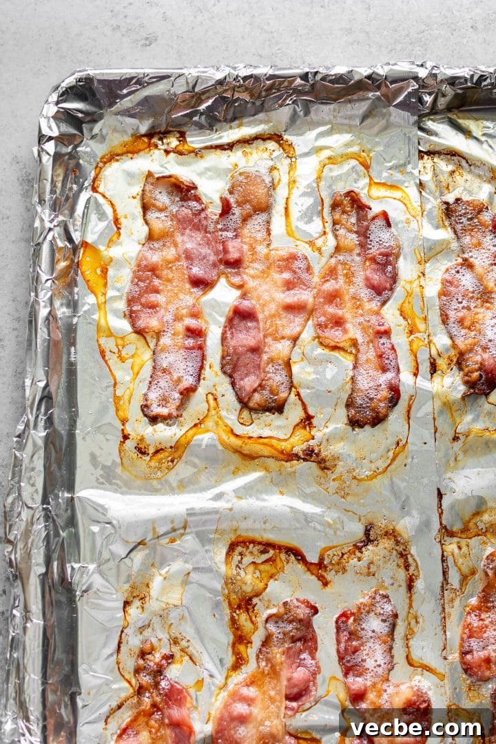 How to Cook Bacon in the Oven for Crispy Strips 4 crispy bacon cooked in the oven on a baking sheet