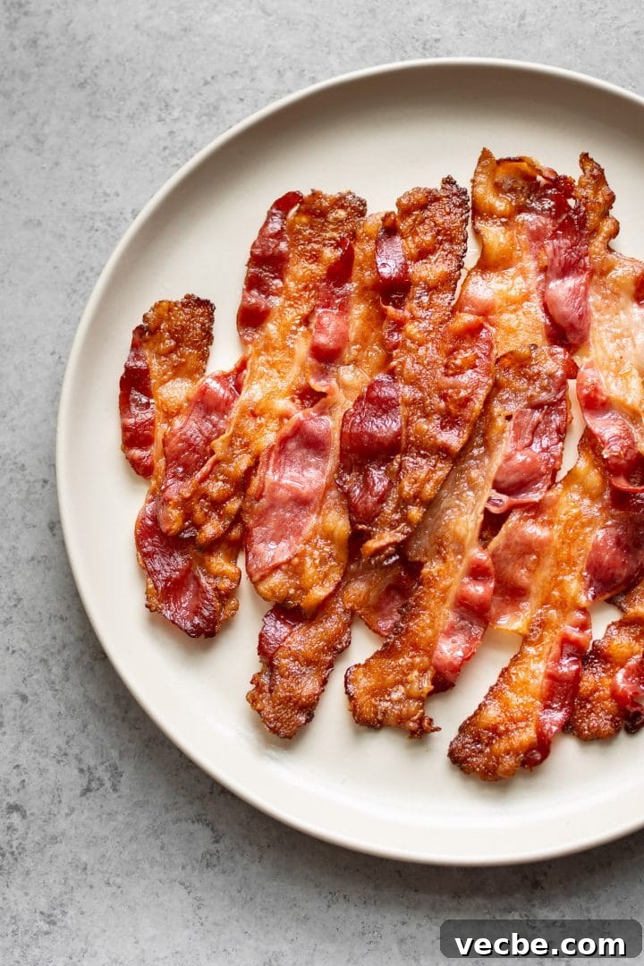 How to Cook Bacon in the Oven for Crispy Strips 5 oven bacon on a plate