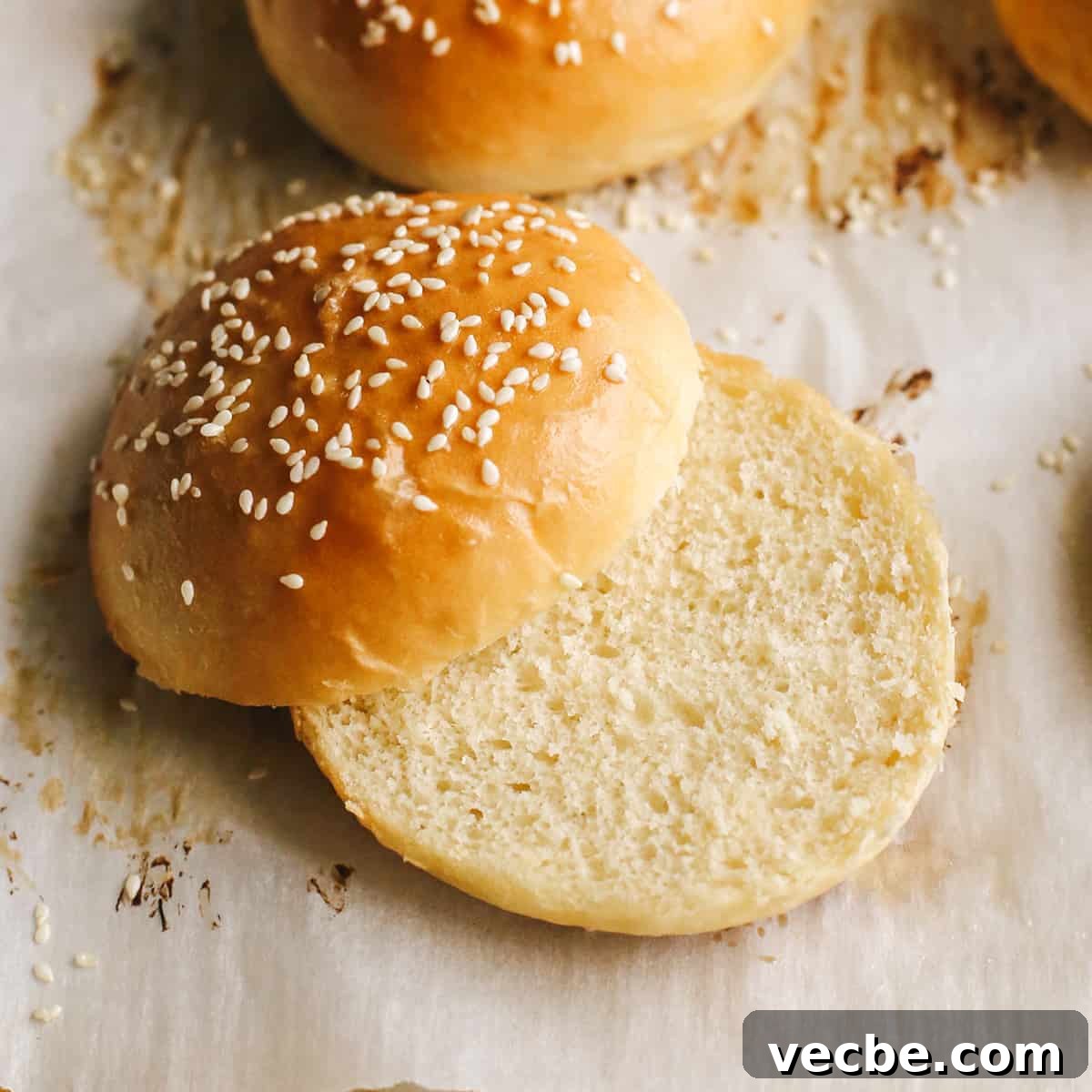 Homemade hamburger buns that are soft, buttery, and perfect for burgers. up close photos of a Homemade Burger Bun cut in half