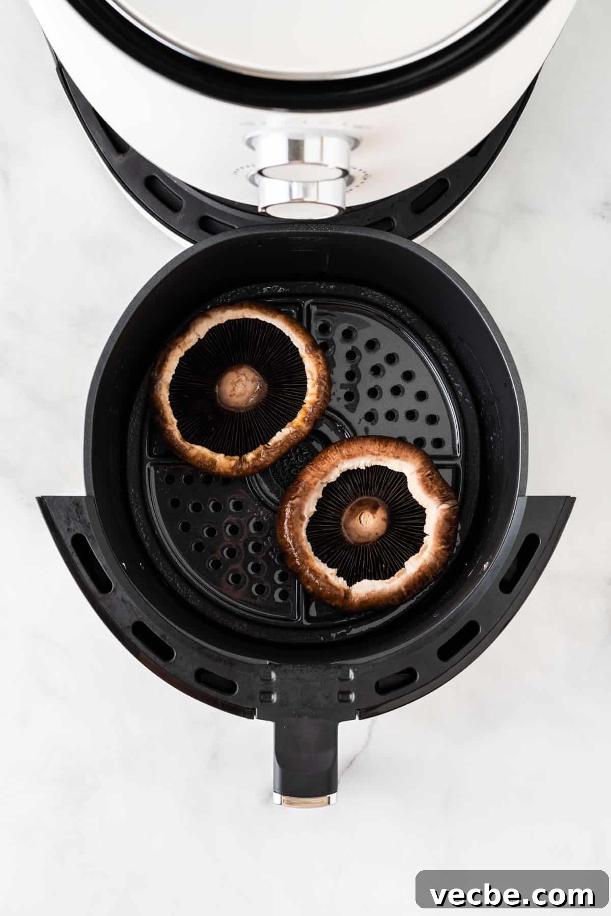 Crispy Air Fryer Portobello Mushrooms Recipe 6 adding the portobello mushrooms to the air fryer