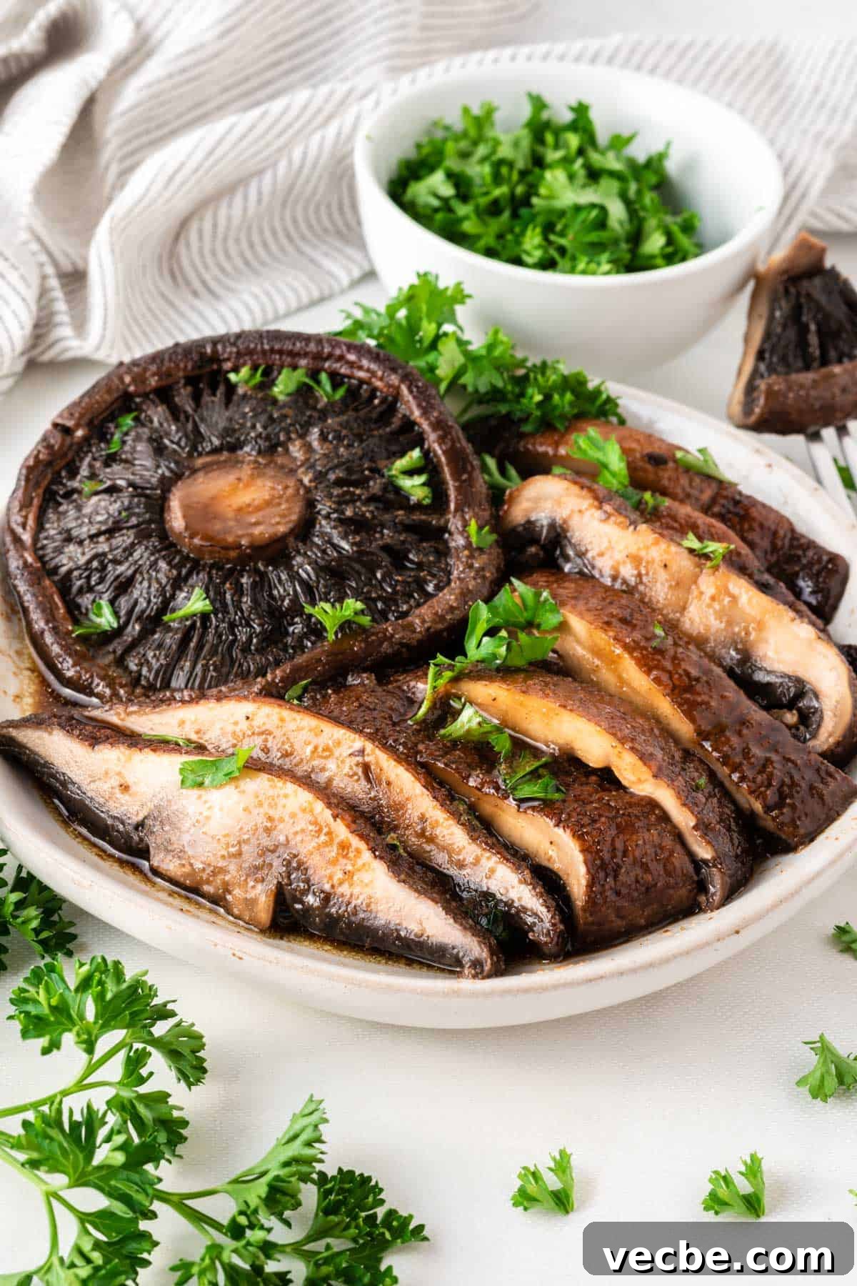 Crispy Air Fryer Portobello Mushrooms Recipe 9 portobello mushrooms cut into slices topped with parsley on a plate