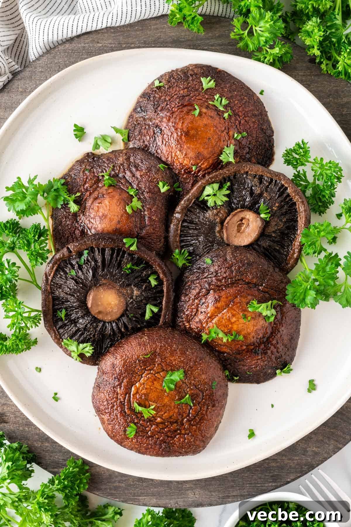 Crispy Air Fryer Portobello Mushrooms Recipe 10 portobello mushrooms topped with parsley on a plate