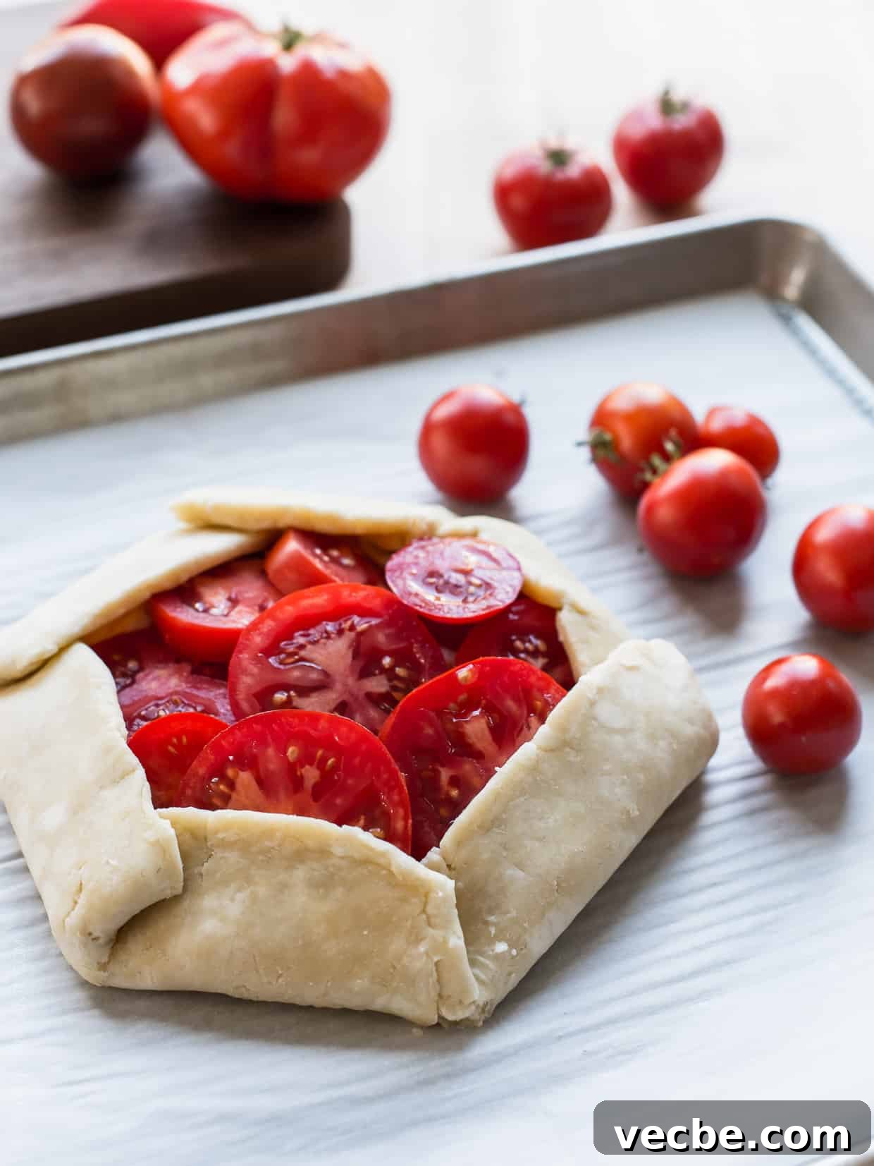 Rustic Tomato and Ricotta Galette Recipe 5 A flaky crust on a baking sheet ready for the oven.