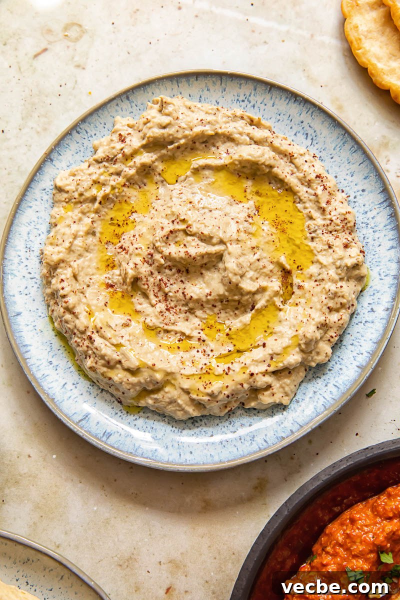 Smoky Baba Ganoush Recipe with Sumac 6 eggplant and tahini spread on a blue plate