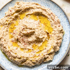 Smoky Baba Ganoush Recipe with Sumac 7 top down view of baba ganoush spread on blue plate