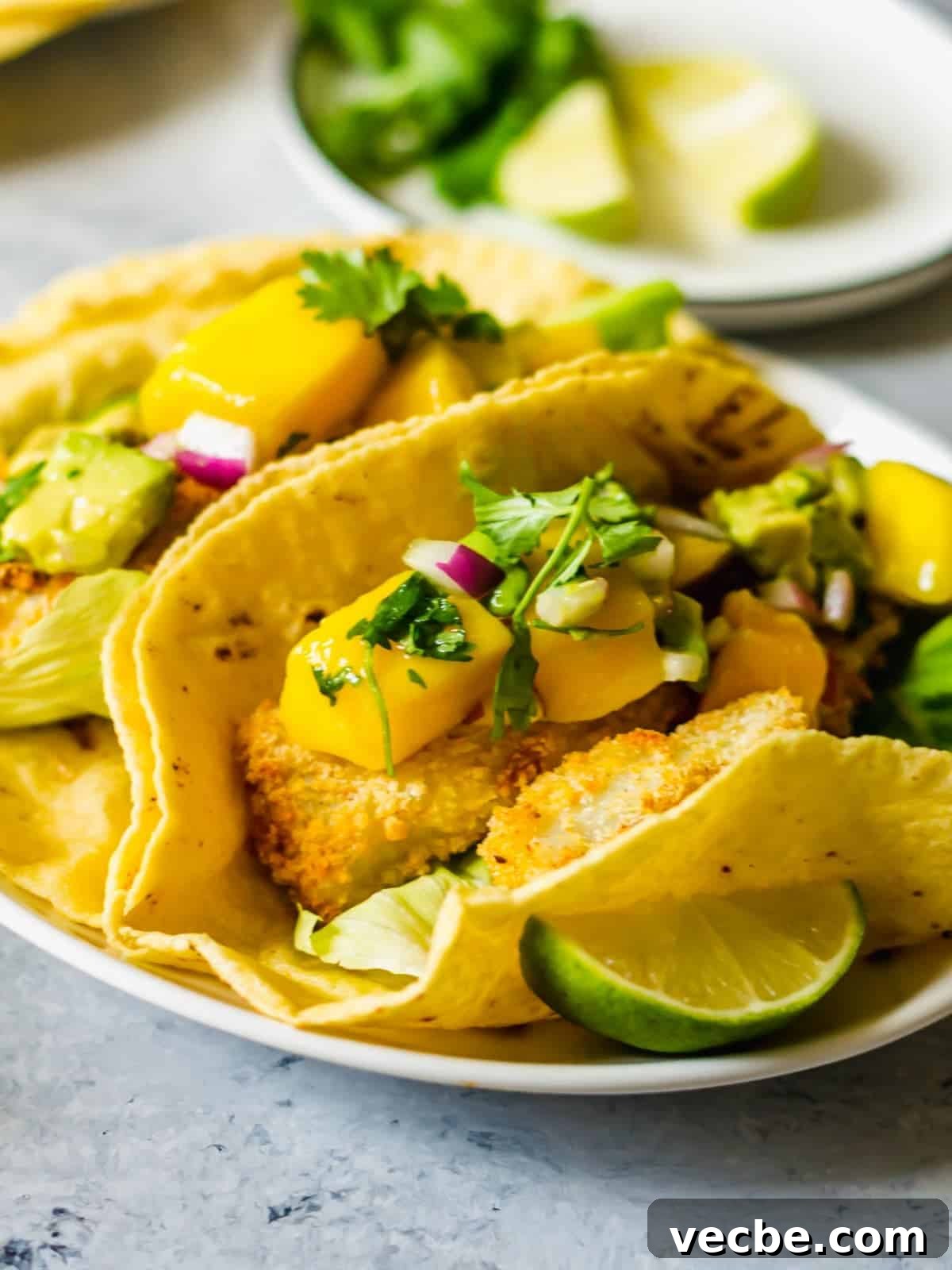 Crispy Fish Tacos with Fresh Mango Salsa Recipe 10 Crispy white fish tacos on a plate.