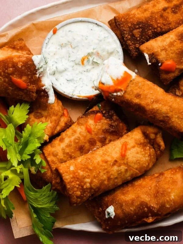 Yogurt-Marinated Grilled Chicken Skewers Recipe 10 Crispy buffalo chicken egg rolls with dipping sauce and celery garnish on a platter.