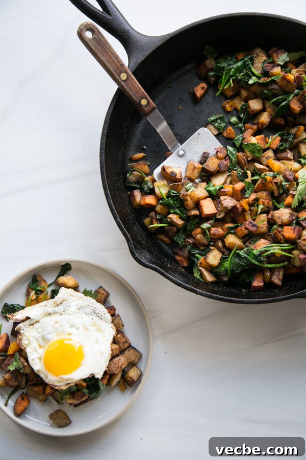 30-Minute Low FODMAP Breakfast Hash Recipe 13 overhead of skillet with dairy-free low fodmap breakfast hash next to plate with a fried egg