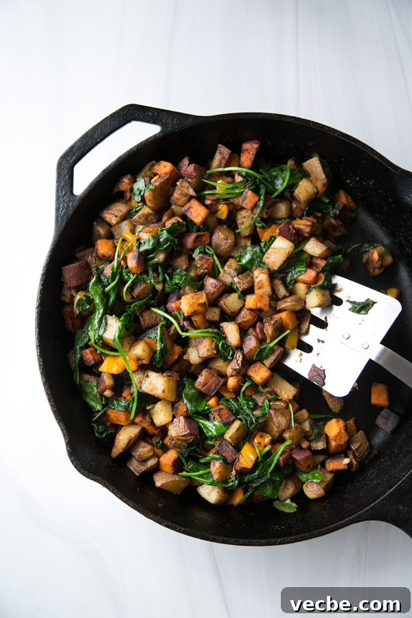 30-Minute Low FODMAP Breakfast Hash Recipe 10 skillet with gluten-free low fodmap breakfast hash with wilted spinach and spatula