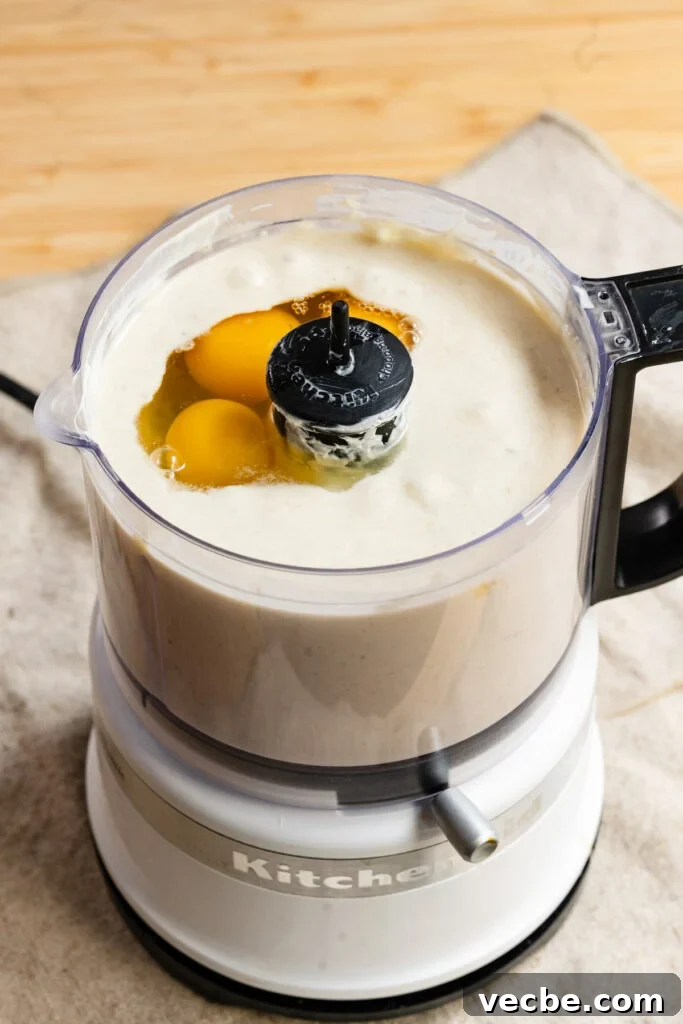 Moist Banana Layer Cake with Honey Buttercream Recipe 6 Eggs and banana batter in a mini food processor.