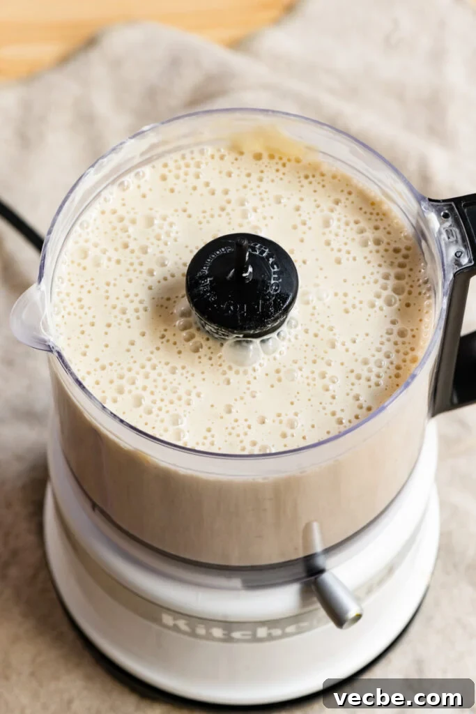 Moist Banana Layer Cake with Honey Buttercream Recipe 7 Liquid banana cake batter in a food processor.