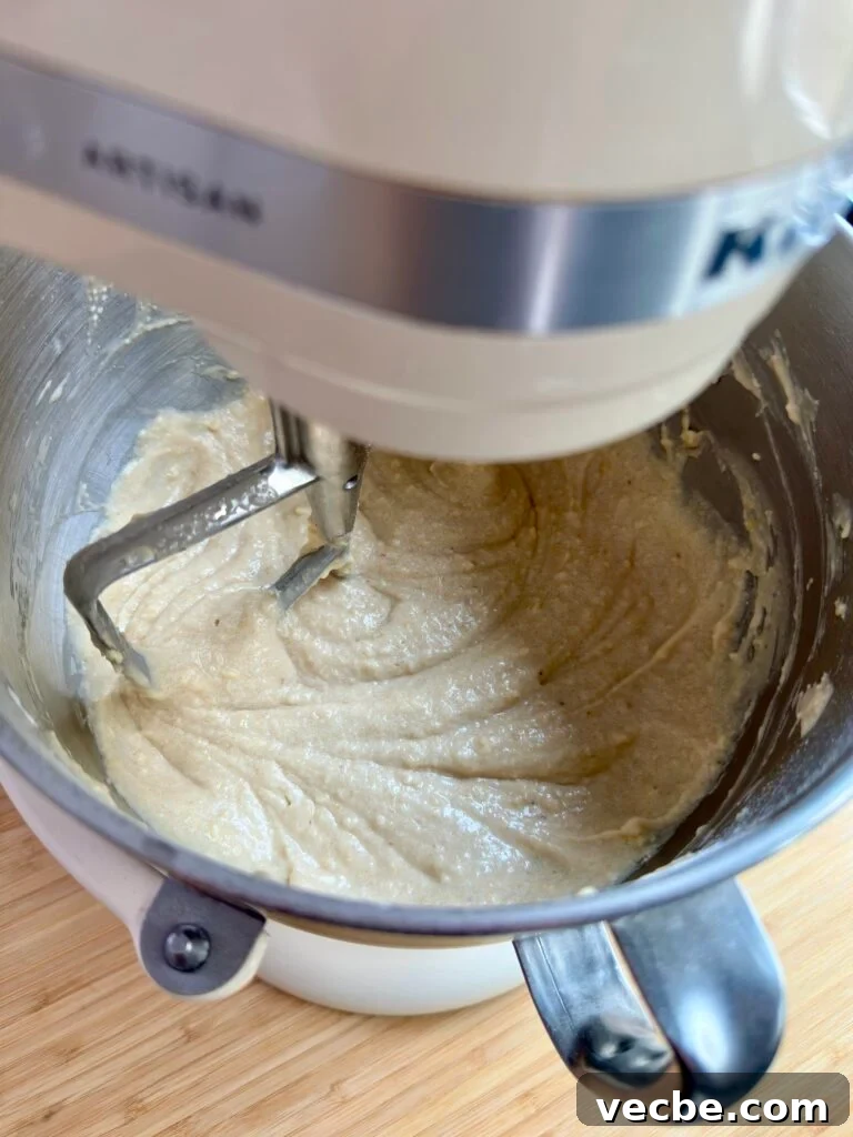 Moist Banana Layer Cake with Honey Buttercream Recipe 10 Banana cake batter being mixed in a stand mixer with paddle attachment.