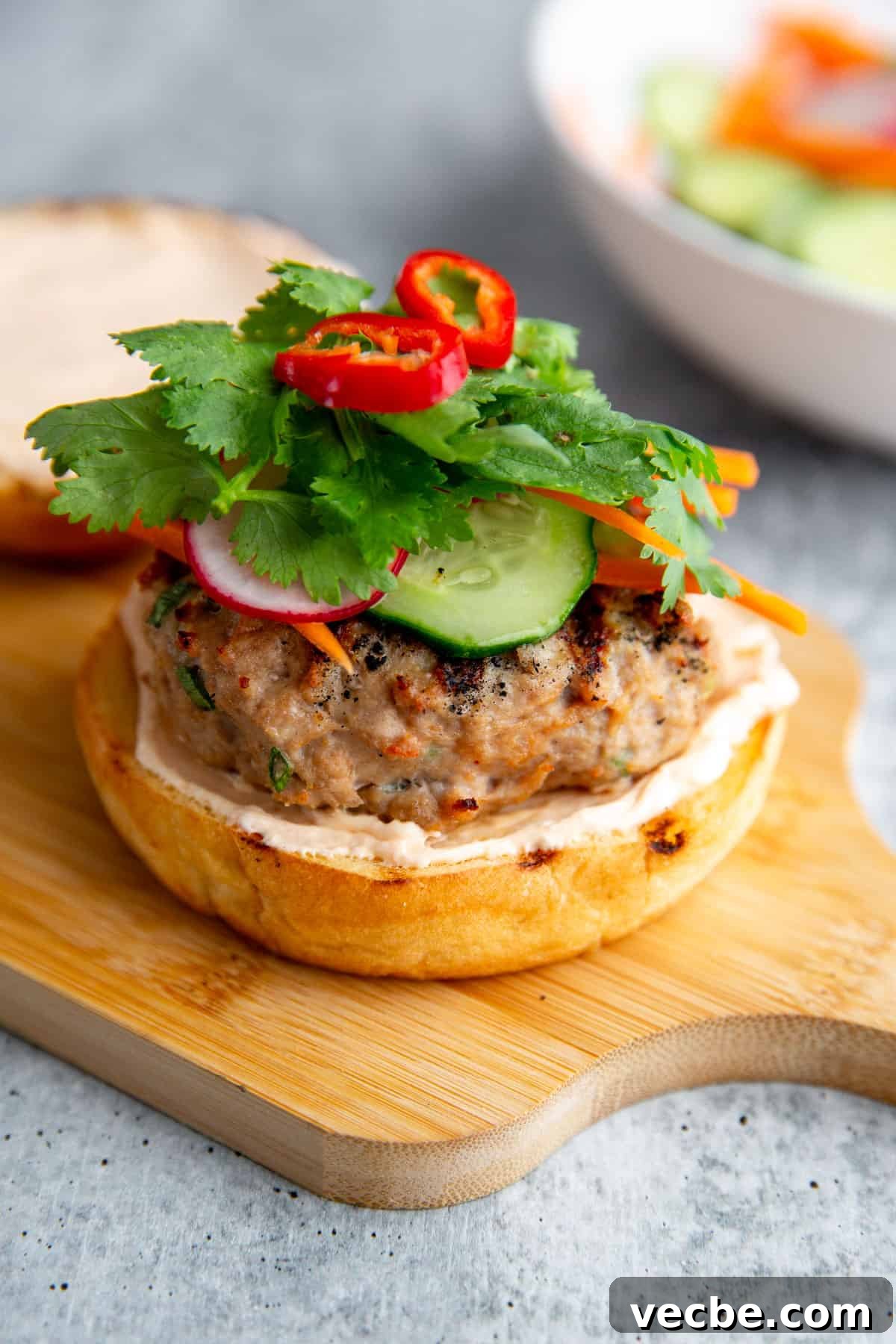Banh Mi Burger Recipe with Sriracha Cream Cheese 2 a banh mi burger without the top bun piled will pickled veggies and fresh herbs