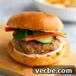 Banh Mi Burger Recipe with Sriracha Cream Cheese 12 a banh mi burger on a cutting board