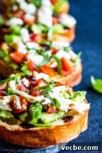 Caprese Avocado Toast Caprese avocado toast in a line on a blue counter.