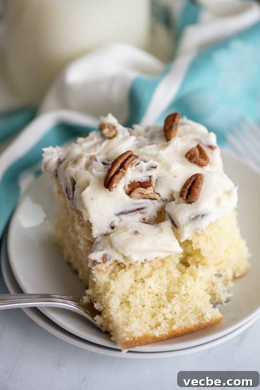 Italian Cream Cake Recipe with Pecan Cream Cheese Frosting 2 a piece of italian cream cake with pecan cream cheese icing.