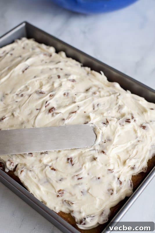 Italian Cream Cake Recipe with Pecan Cream Cheese Frosting 12 Spread pecan cream cheese icing on top of cake.