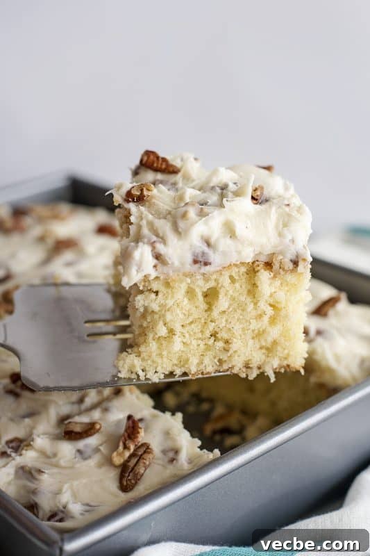 Italian Cream Cake Recipe with Pecan Cream Cheese Frosting 14 Italian Cream Cake slice on spatula.