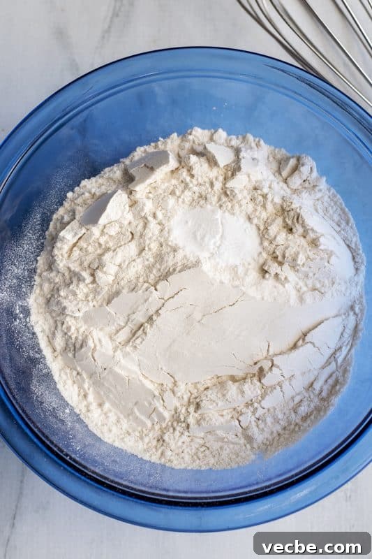 Italian Cream Cake Recipe with Pecan Cream Cheese Frosting 7 Flour and baking soda in a bowl.