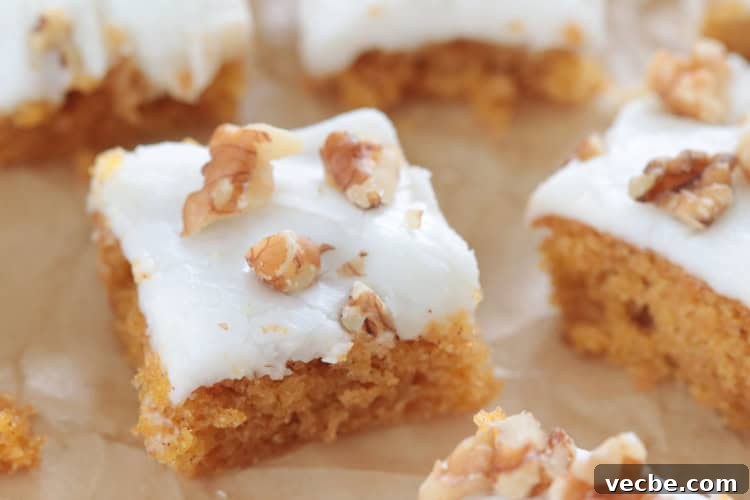 25 Irresistible Easter Dessert Recipes to Try 14 carrot cake bars on parchment paper