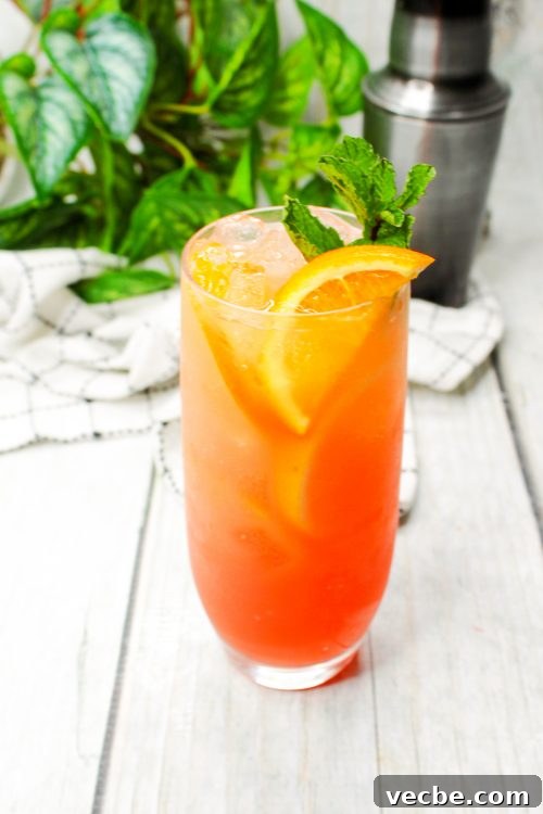 Azalea Cocktail Recipe with Vodka and Pineapple Juice 6 a gin and grenadine cocktail garnished with an orange slice and fresh mint.