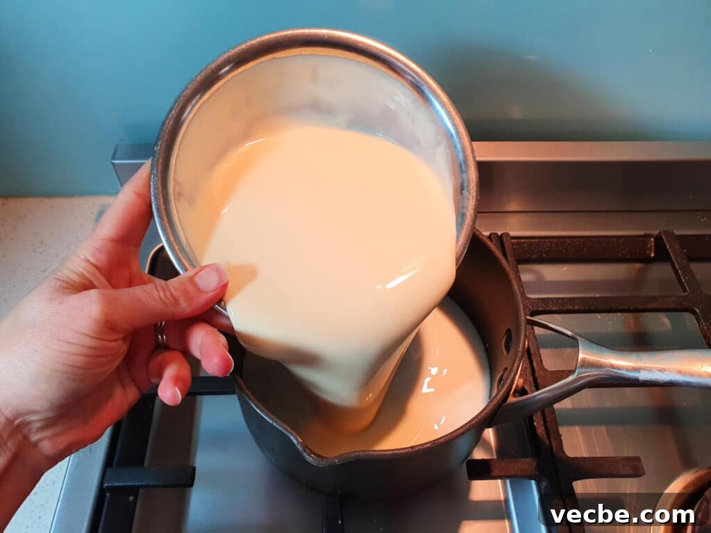 Cookies and Cream Ice Cream Recipe 7 adding cream to pot on stove.