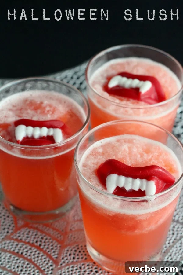 Slushy punch is fruity and fizzy and perfect for any occasion. Adding wax fangs make it a Halloween must! Halloween Slushy Punch Recipe with Wax Lips.