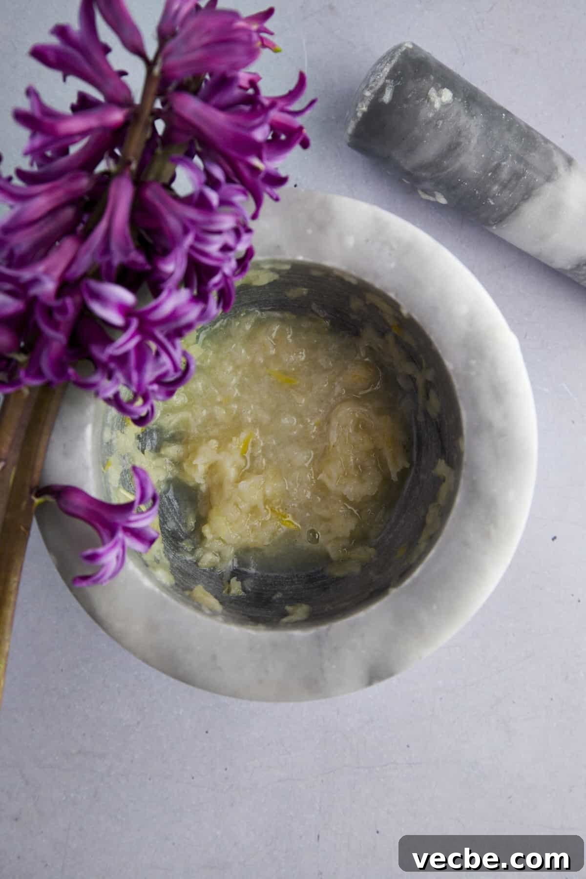 How to Make Chunky Garlic Hummus (Masabaha) 3 Garlic paste in a mortar and pestle