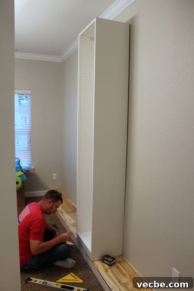 DIY IKEA Built In Storage Cabinets on a Budget 5 IKEA wardrobes and bookcases attached to a platform for custom built-ins