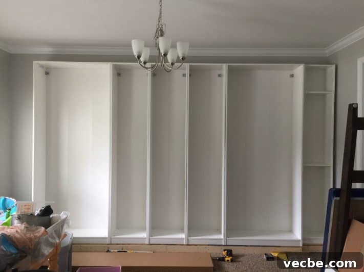 DIY IKEA Built In Storage Cabinets on a Budget 6 Custom IKEA built-ins in progress with wardrobes and bookcases