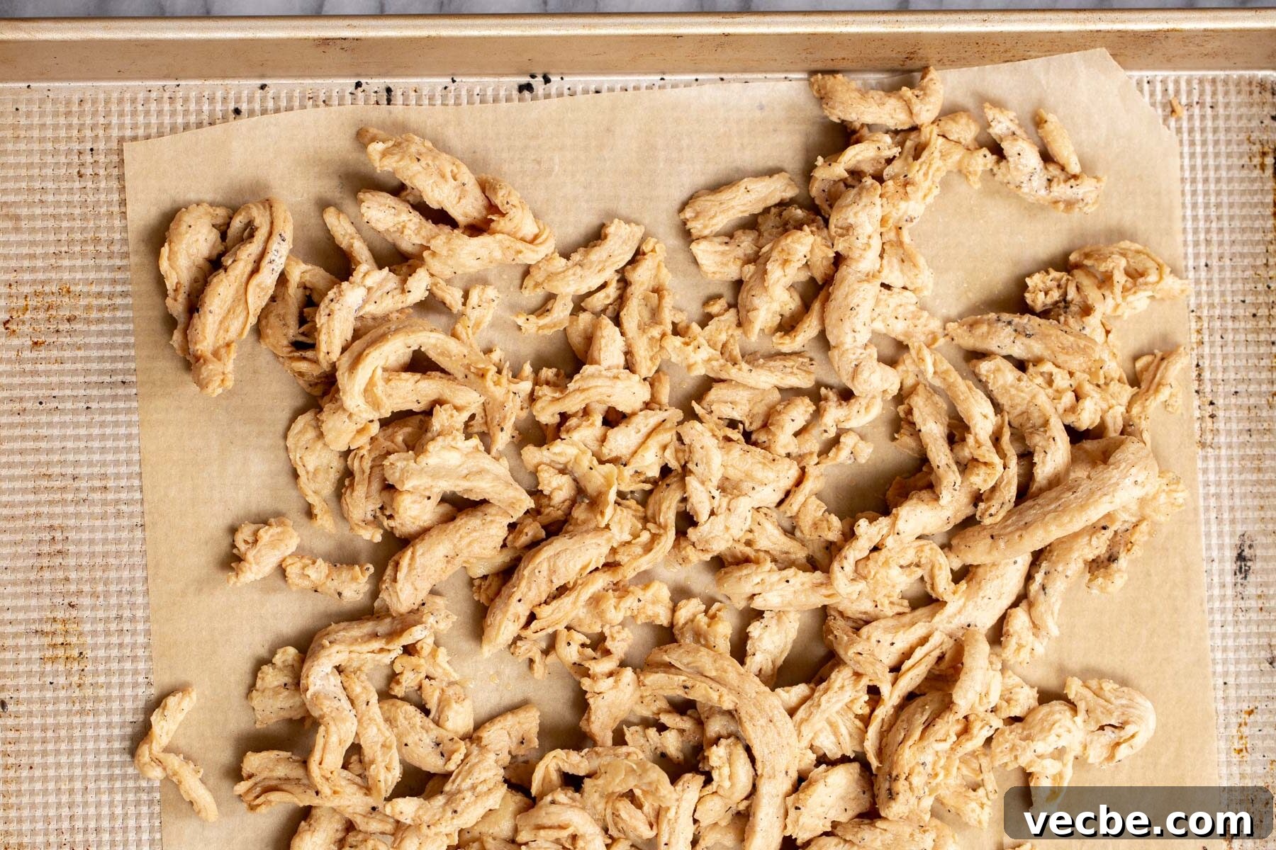 Vegan Chilli Chicken with Soy Curls Recipe 8 baked vegan soy curls on a baking sheet