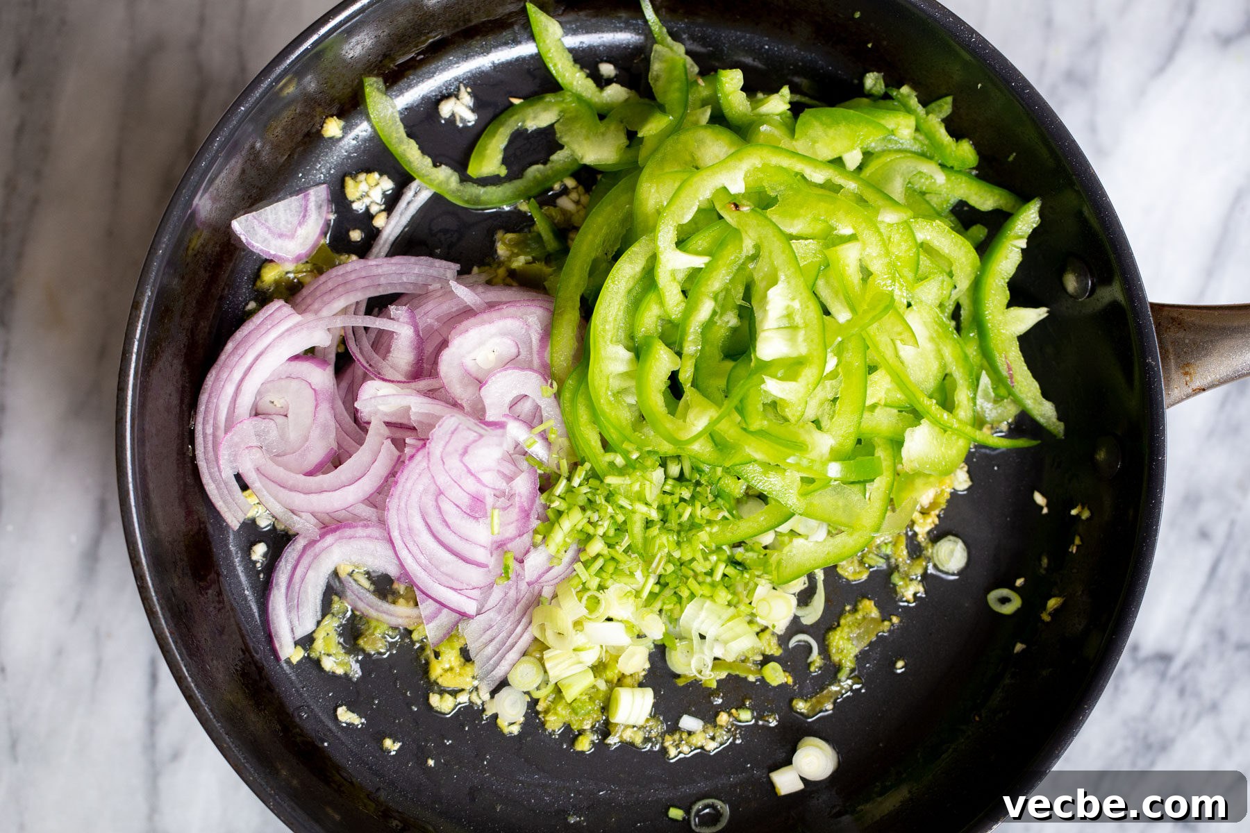 Vegan Chilli Chicken with Soy Curls Recipe 10 sliced onion and green bell peppers in a sauteeing pan