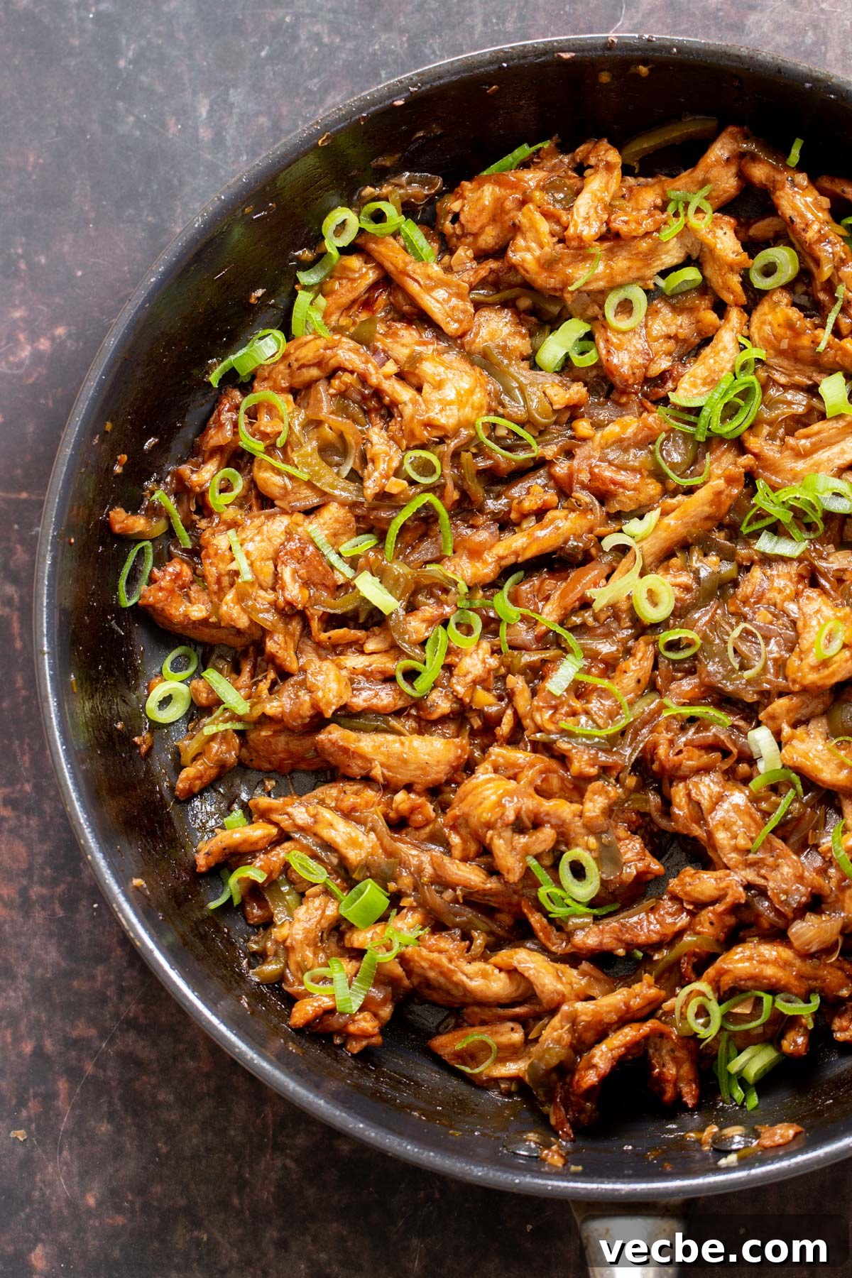 Vegan Chilli Chicken with Soy Curls Recipe 14 Indo Chinese Soy Curl chilli Chicken in a skillet sprinkled with green onions