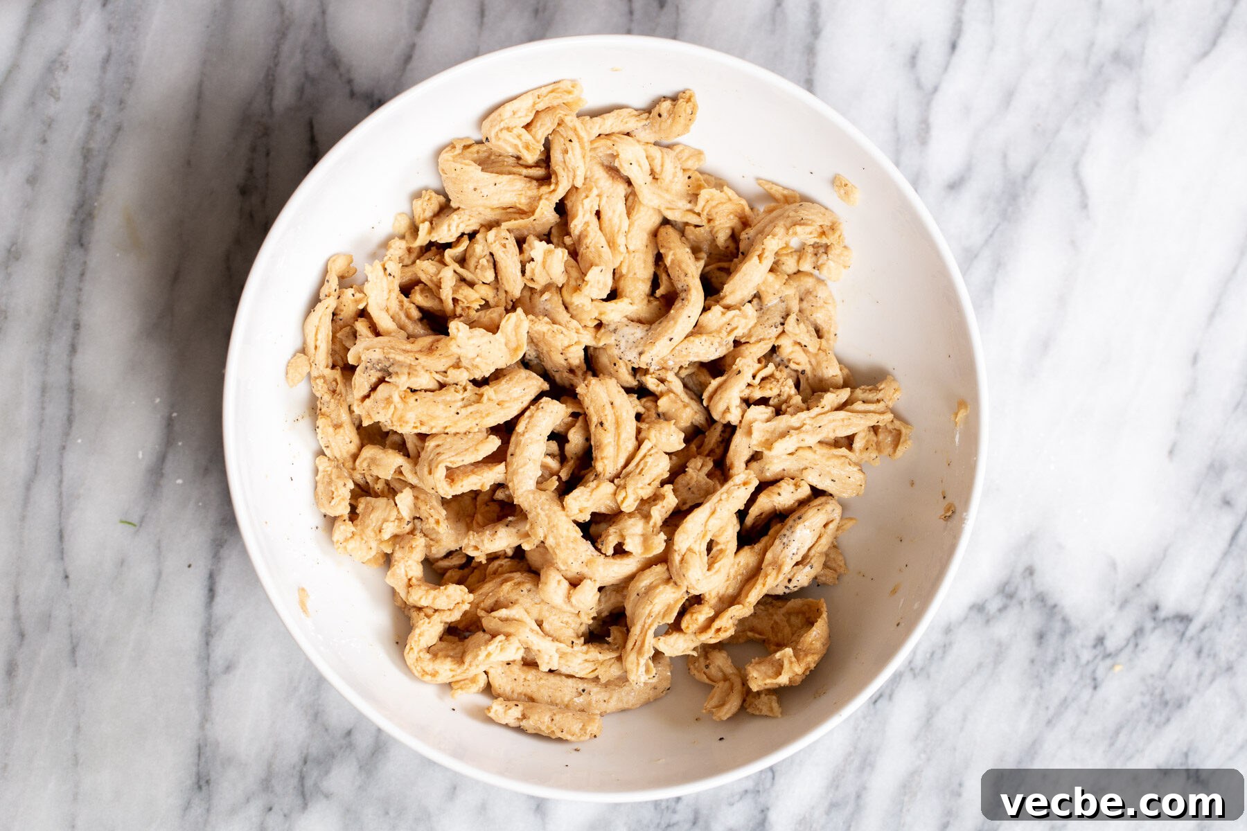 Vegan Chilli Chicken with Soy Curls Recipe 7 soaked vegan marinated soy curls in a white bowl