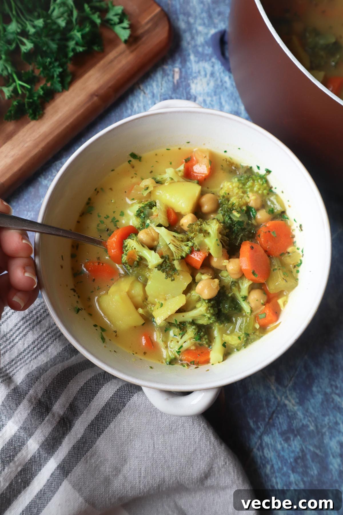 Creamy Vegan Chickpea Broccoli Soup 2 bowl with broccoli carrot potato chickpea soup topped with fresh parsley