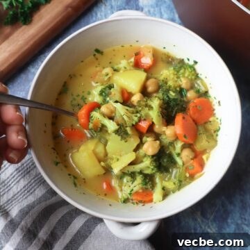 Creamy Vegan Chickpea Broccoli Soup 8 bowl with broccoli carrot potato chickpea soup topped with fresh parsley