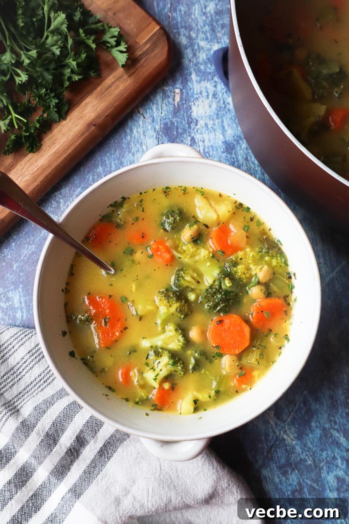 Creamy Vegan Chickpea Broccoli Soup 5 white bowl with chickpea broccoli soup with spoon in the bowl