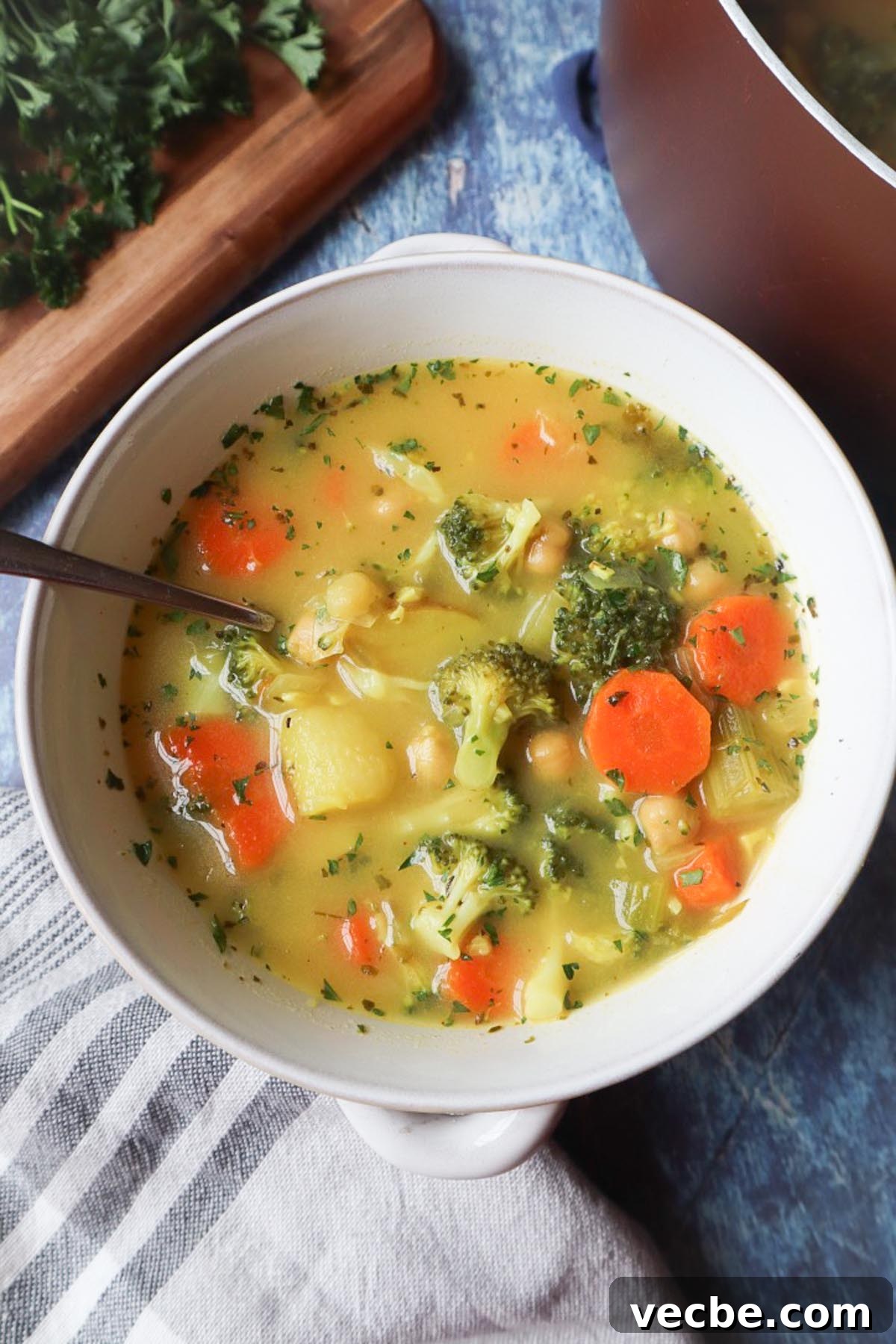 Creamy Vegan Chickpea Broccoli Soup 6 bowl with broccoli carrot potato chickpea soup topped with fresh parsley