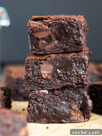 Stack of dark chocolate brownies against a dark background