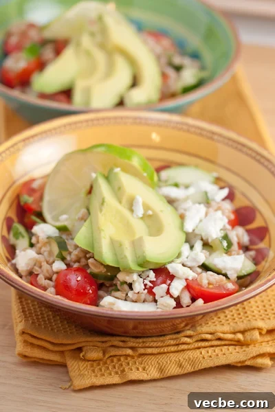 Bowls of chilled farro salad with avocado and feta.
