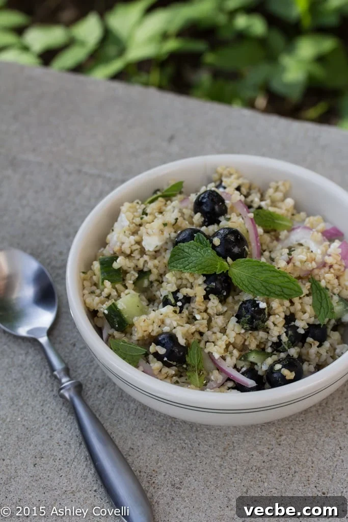Blueberry and Feta Bulgur Salad with Mint Dressing with a spoon alongside.