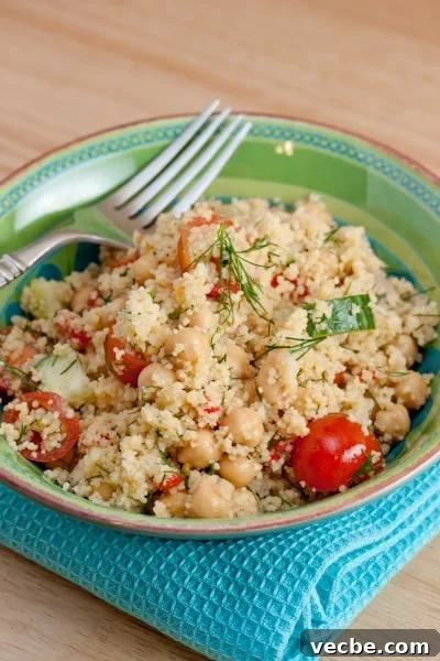 Bowl of couscous with fresh veggies and dill.