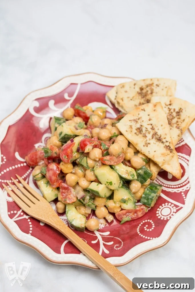 Plate of Falafel-Spiced Chickpea Salad with Tahini-Lemon Vinaigrette and a fork.