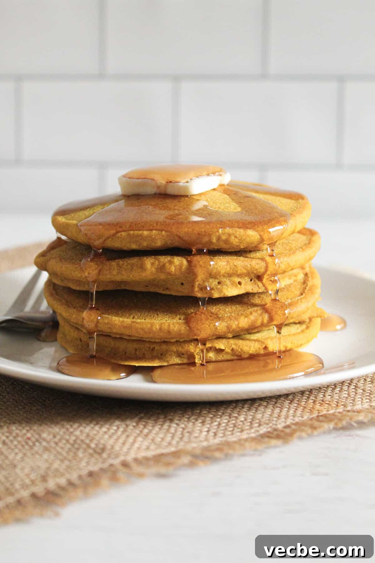Fluffy Gluten-Free Buckwheat Pancakes Recipe 2 buckwheat pancakes with butter and syrup on a plate