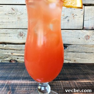hurricane cocktail in a hurricane glass with a wooden background