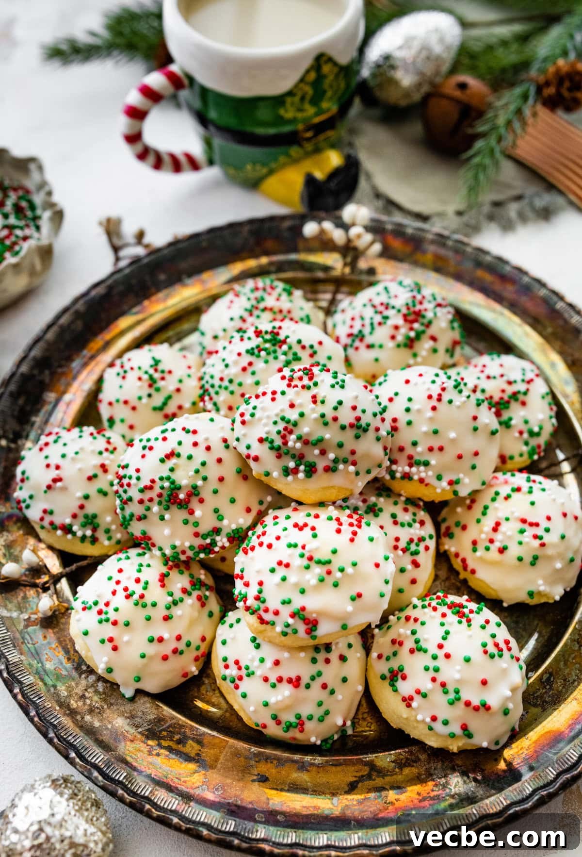65+ Christmas Dessert Recipes Your Guests Will Love 2 Italian Christmas cookies on a beautiful platter with Christmas decoration around it.