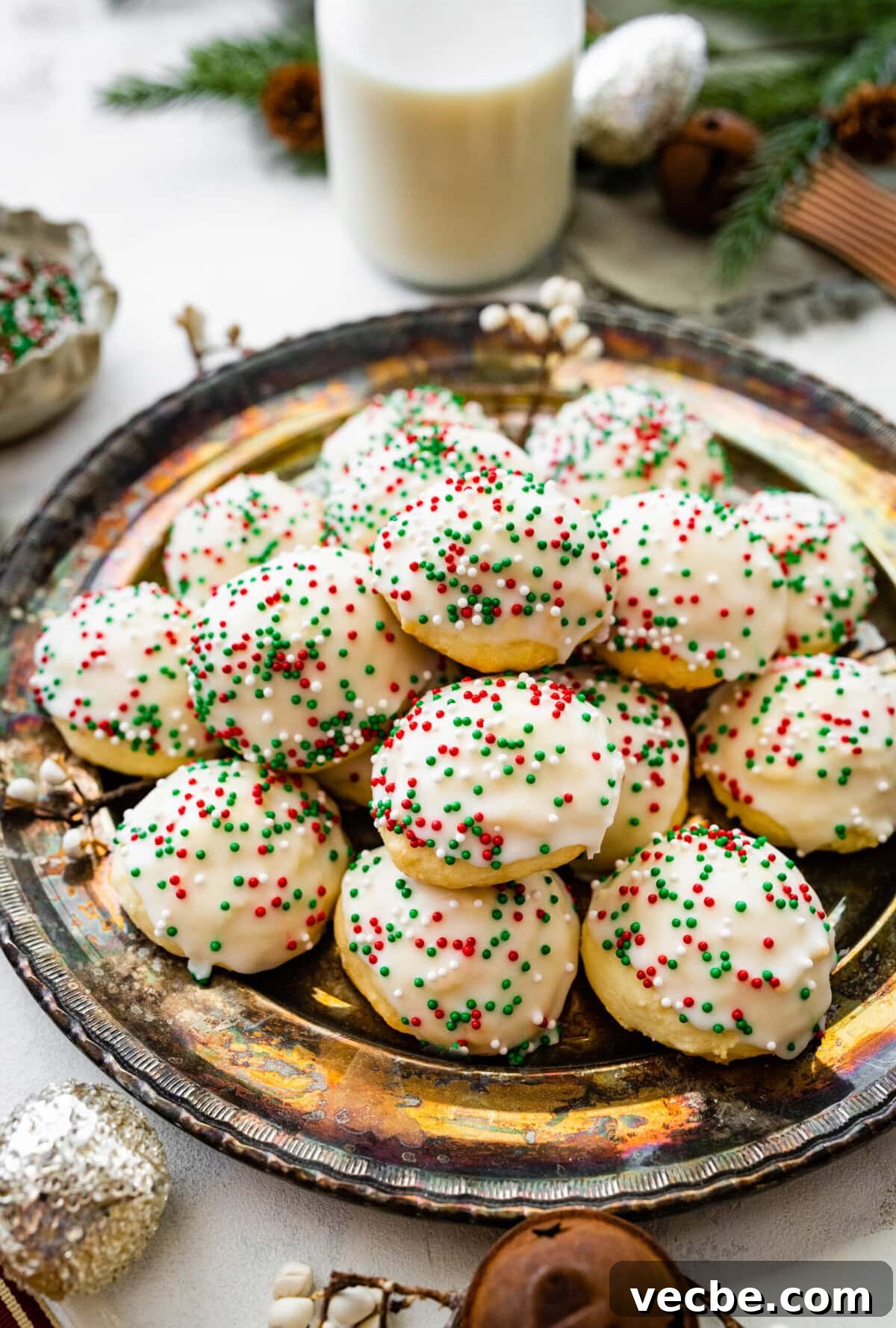 65+ Christmas Dessert Recipes Your Guests Will Love 14 Italian Christmas cookies on a beautiful platter with Christmas decoration around it.